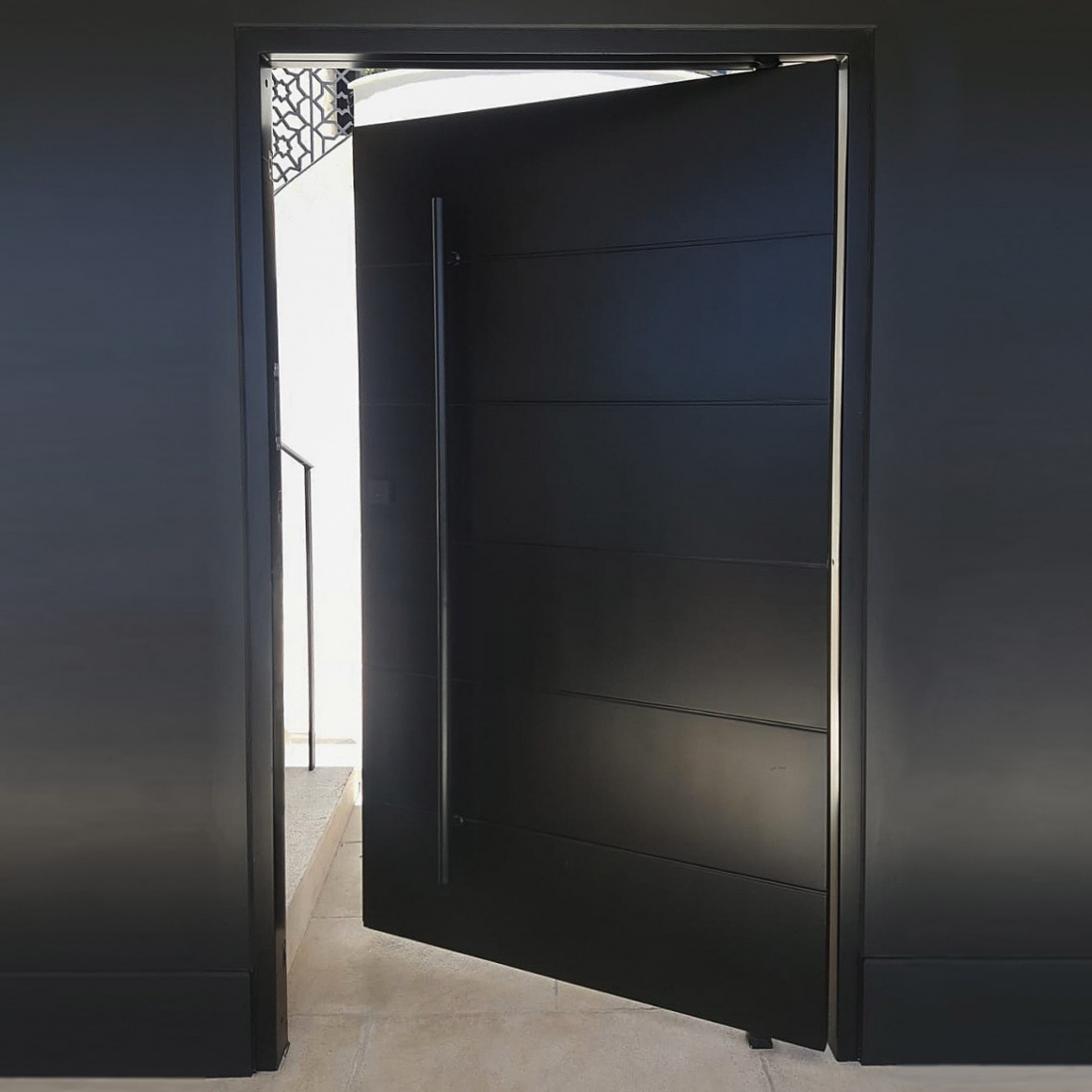 luxury black pivot door with steel horizontal slats
