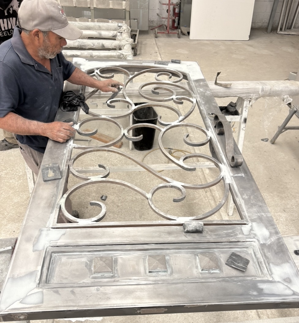 Man detailing a steel door